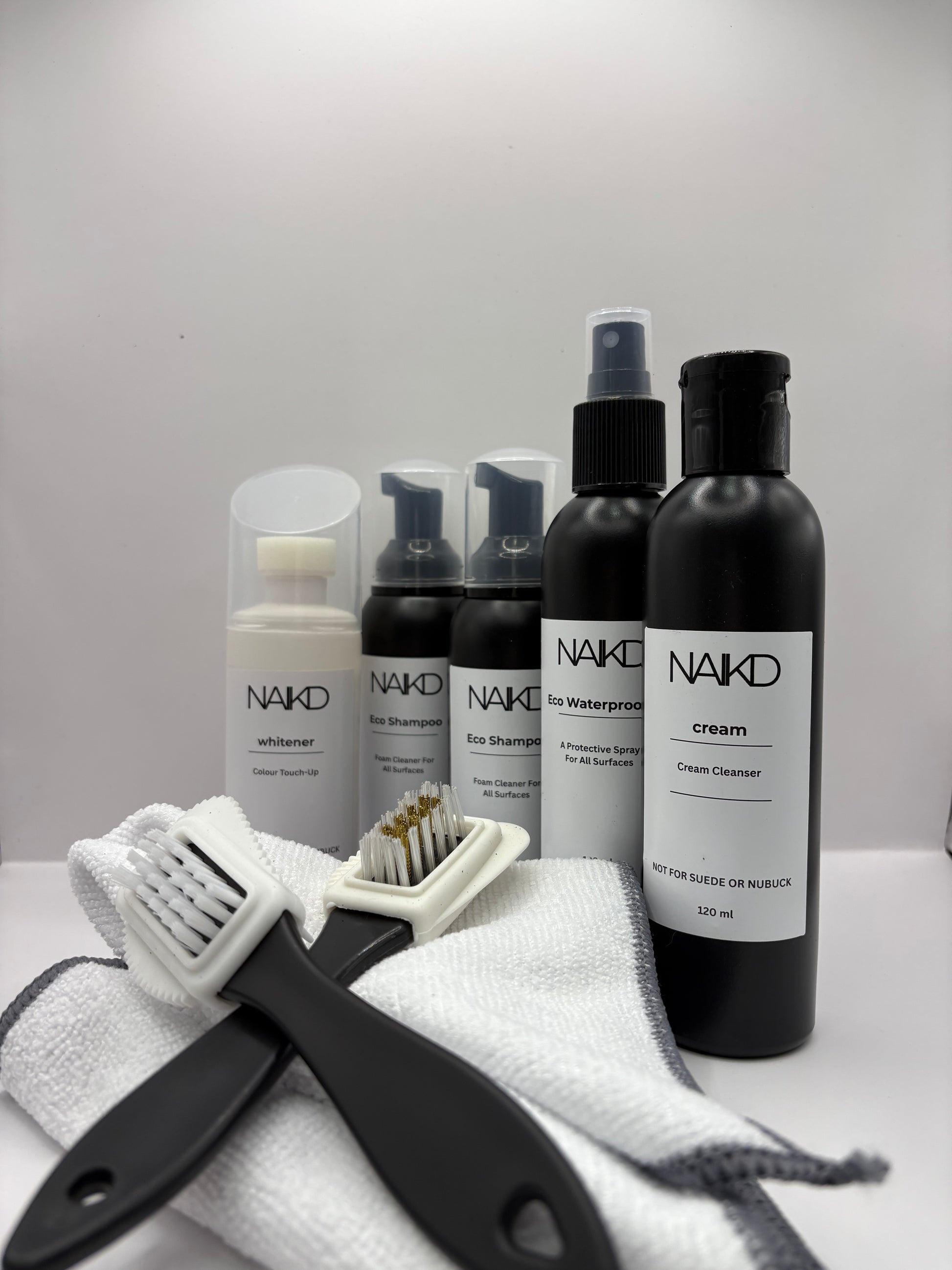 Complete shoe care restoration pack with eco shampoo, cream cleaner, waterproofer, whitener, two brushes and two microfibre cloths